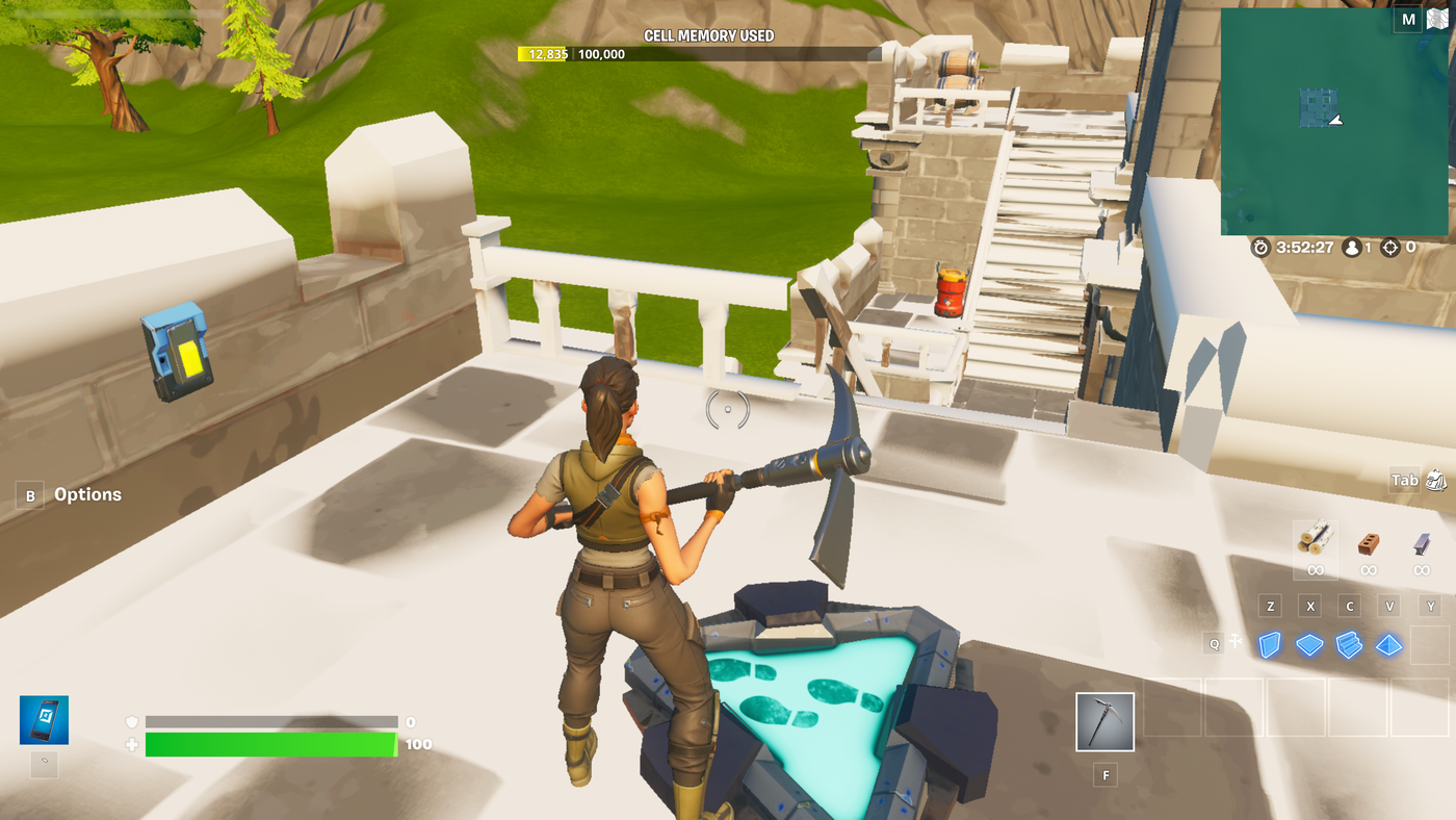 A player standing between a Button device and an Explosive device.